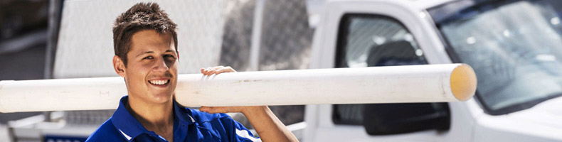 one of our Columbia plumbers carrying a sewer pipe